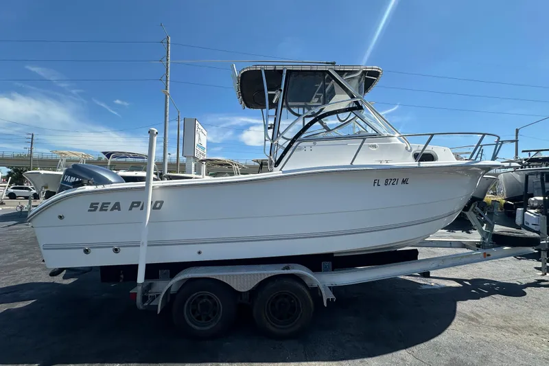 Slide: The Image of 2004 Sea Pro 220 Walk Around boat on trailer under clear blue sky. - 1