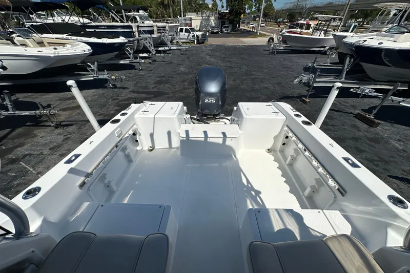 Slide: The Image of 2004 Sea Pro 220 Walk Around boat with outboard motor, docked among other boats. - 11
