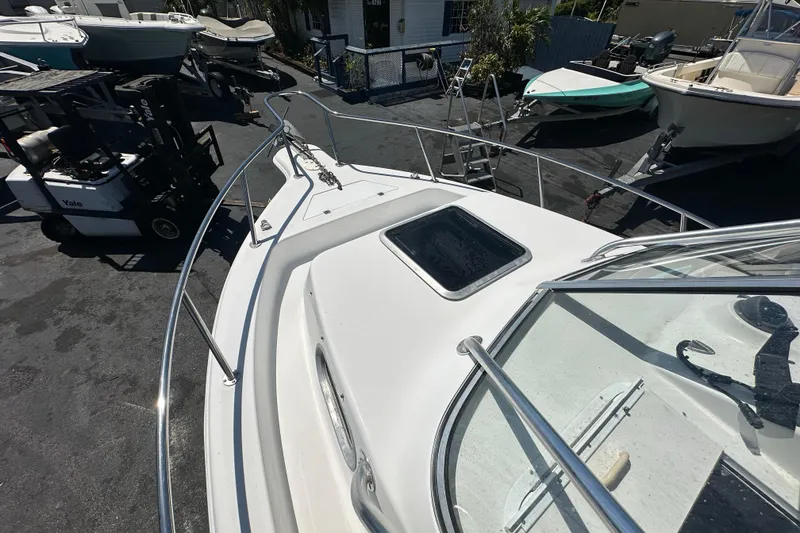 Slide: The Image of 2004 Sea Pro 220 Walk Around boat on display, surrounded by other boats and equipment. - 15