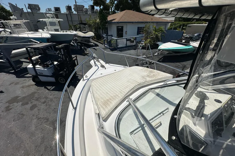 Slide: The Image of 2004 Sea Pro 220 Walk Around boat on display at a marina with other vessels. - 16