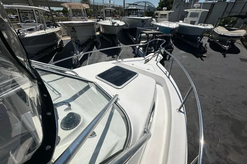Slide: The Image of 2004 Sea Pro 220 Walk Around boat docked among other vessels in a marina. - 17