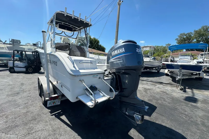 Slide: The Image of 2004 Sea Pro 220 Walk Around boat with Yamaha engine on trailer in sunny marina. - 5