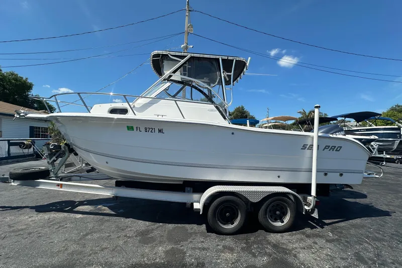 Slide: The Image of 2004 Sea Pro 220 Walk Around boat on trailer under clear blue sky. - 7