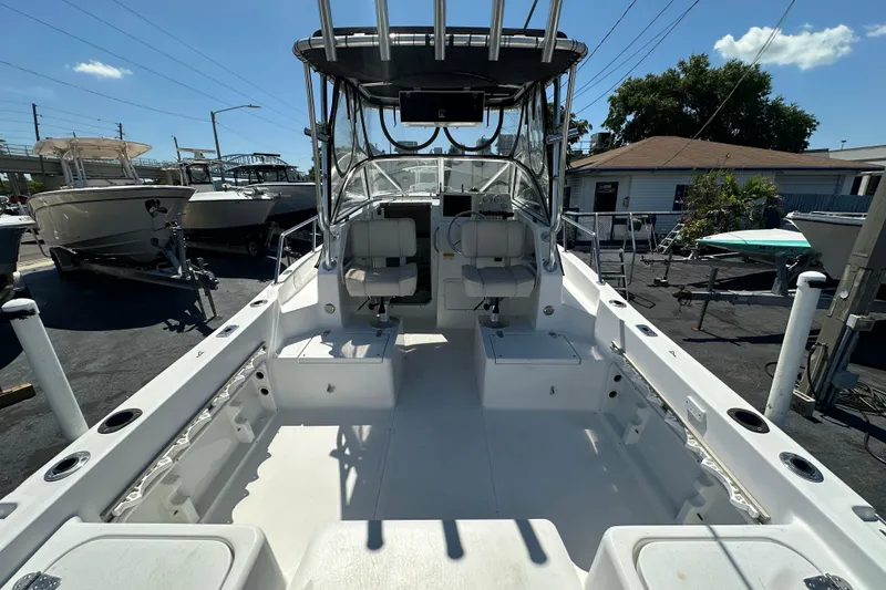 Slide: The Image of 2004 Sea Pro 220 Walk Around boat interior, featuring spacious seating and fishing amenities. - 9