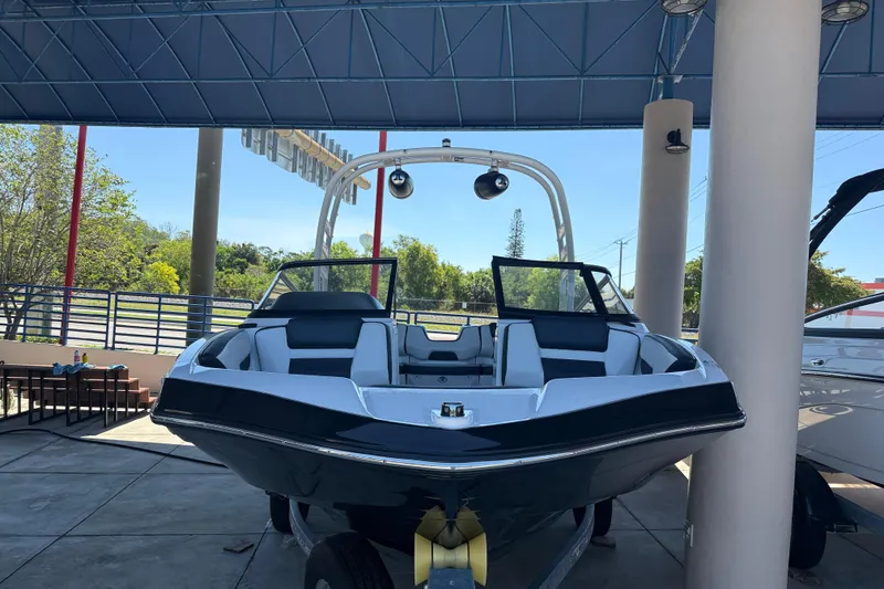 Slide: The Image of 2023 Yamaha Boats 195S displayed in a showroom, showcasing sleek design and modern features. - 10