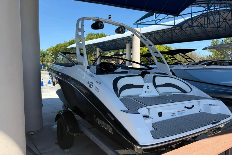 Slide: The Image of 2023 Yamaha Boats 195S, sleek design, displayed outdoors under a canopy. - 12