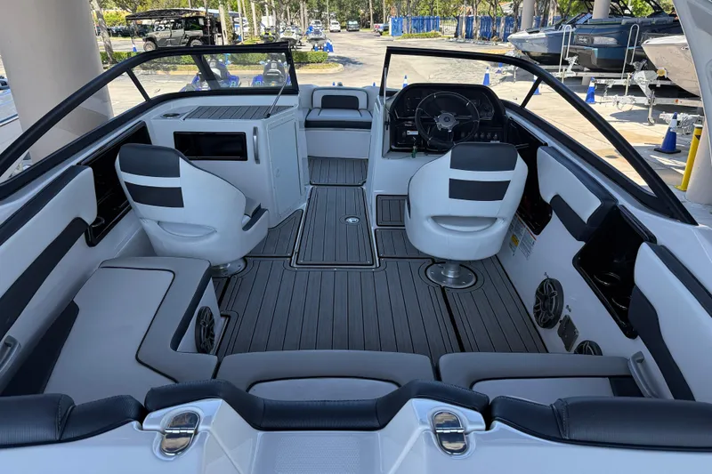 Slide: The Image of Interior view of 2023 Yamaha Boats 195S, featuring sleek seating and modern dashboard. - 15
