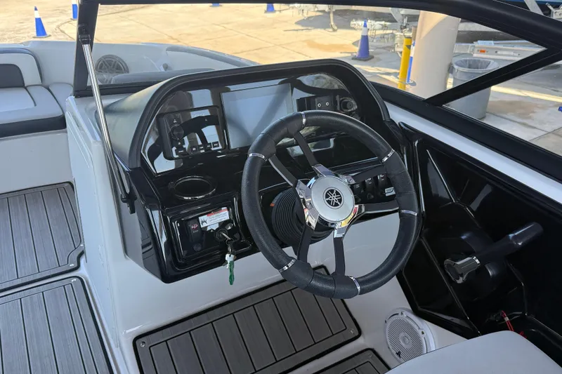 Slide: The Image of 2023 Yamaha Boats 195S dashboard with steering wheel and controls, featuring modern design. - 22