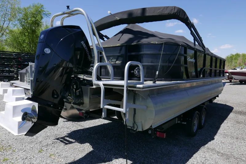 Slide: The Image of 2019 Bentley 253 Admiral RE pontoon boat with Mercury outboard engine, parked outdoors. - 13