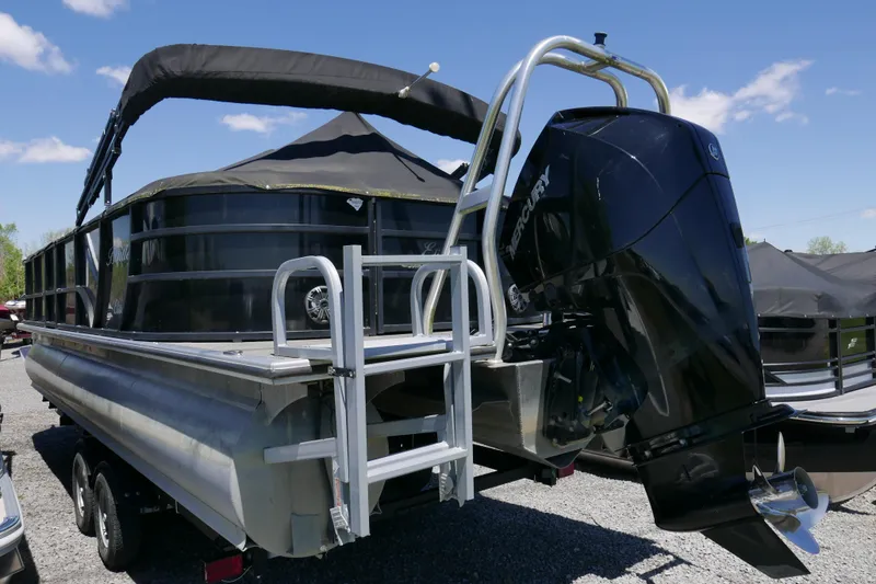 Slide: The Image of 2019 Bentley 253 Admiral RE pontoon boat with Mercury outboard motor, parked on gravel. - 14
