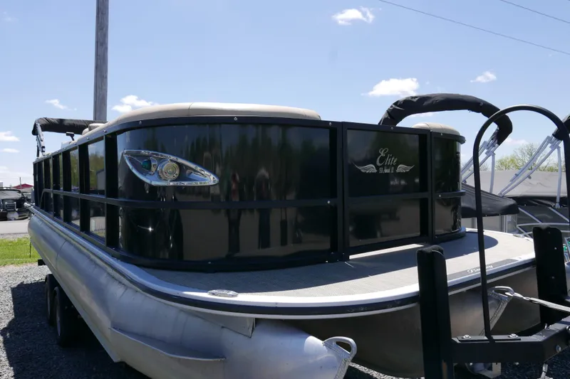 Slide: The Image of 2019 Bentley 253 Admiral RE pontoon boat with sleek black exterior and modern design. - 2