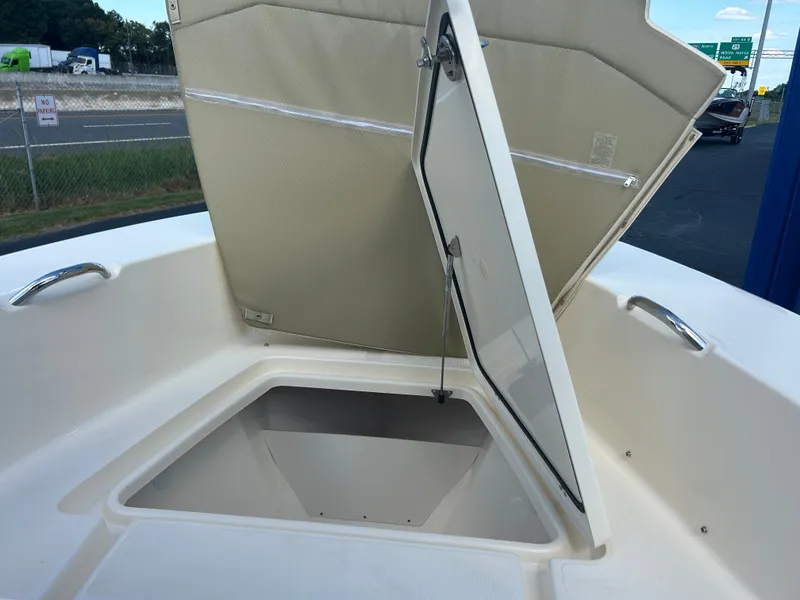 Slide: The Image of An open storage compartment on a 2027 Scout 195 Sportfish boat. - 30