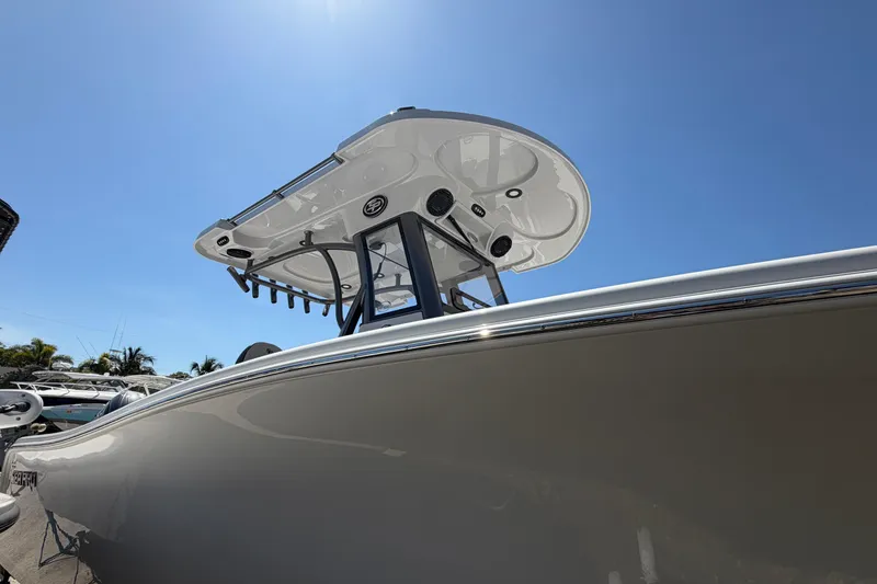 Slide: The Image of Sea Pro 262 DLX 2026 boat with T-top under blue sky. - 11