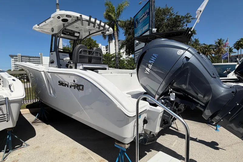 Slide: The Image of 2026 Sea Pro 262 DLX boat with Yamaha engine displayed outdoors. - 2