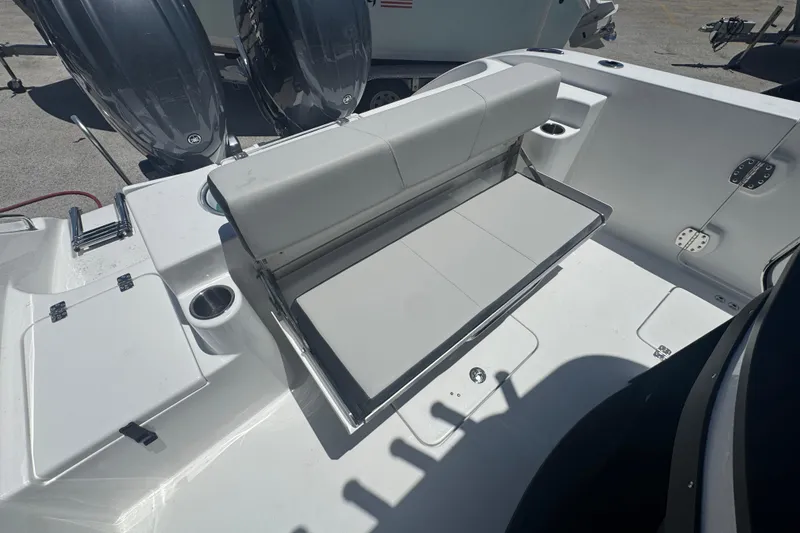 Slide: The Image of Rear seating of 2026 Sea Pro 262 DLX with engines in background. - 22