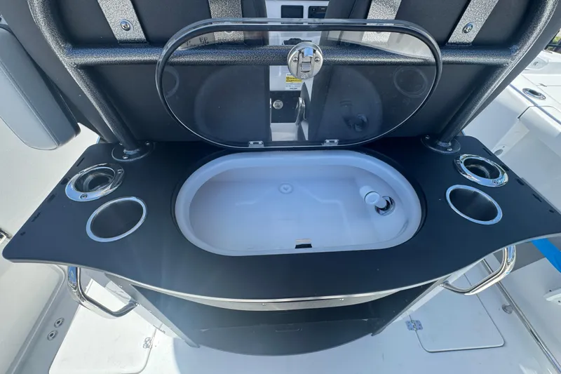 Slide: The Image of 2026 Sea Pro 262 DLX boat kitchenette with sink and cup holders. - 23