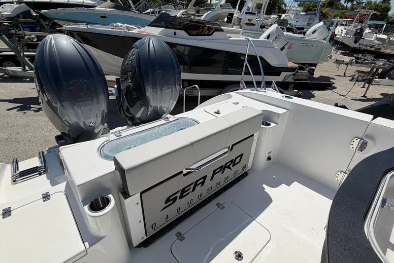 Slide: The Image of 2026 Sea Pro 262 DLX boat with dual engines at the marina. - 26