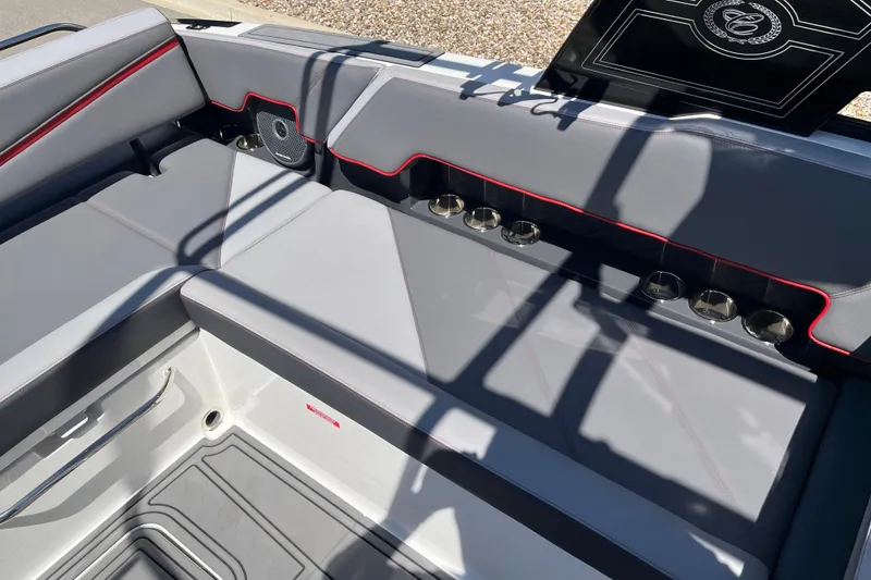 Slide: The Image of 2023 Cobalt R8 Surf boat interior with gray seating and cup holders. - 14