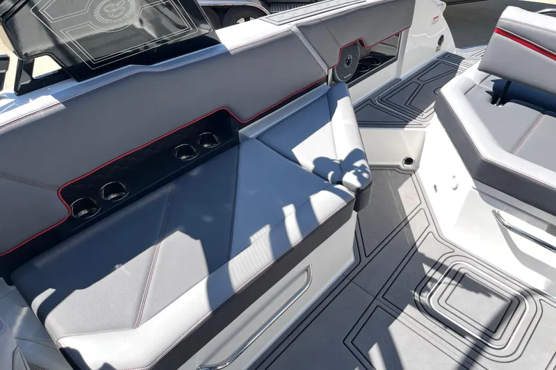 Slide: The Image of 2023 Cobalt R8 Surf boat interior with gray seating and cup holders. - 15