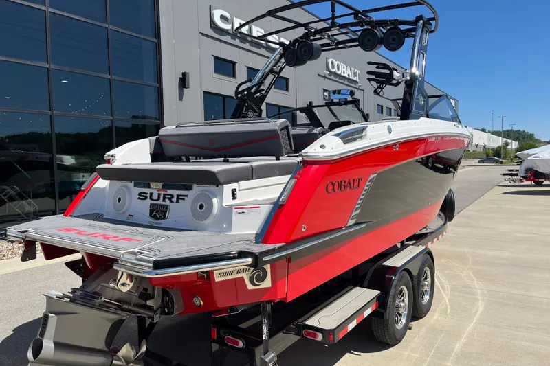 Slide: The Image of 2023 Cobalt R8 Surf boat in red and black, parked outside dealership. - 3