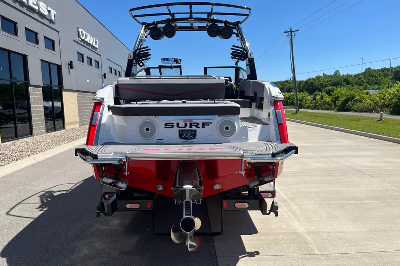 Slide: The Image of 2023 Cobalt R8 Surf boat rear view, parked outdoors near dealership. - 6