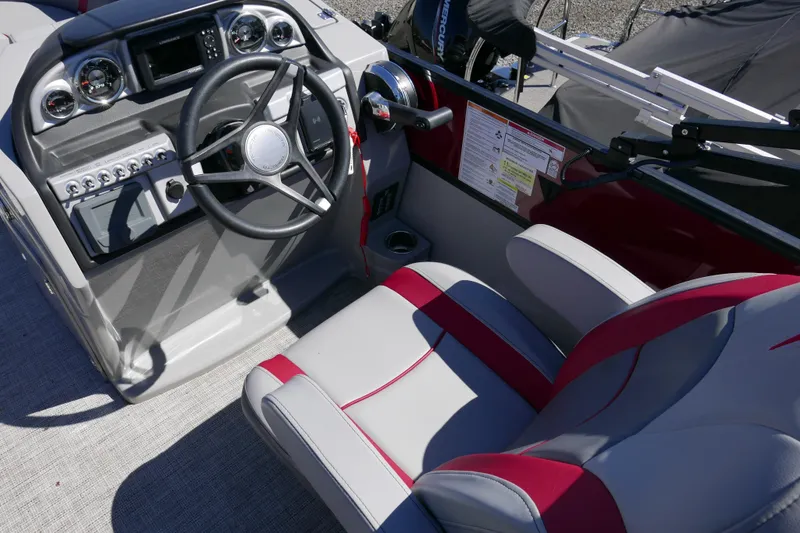 Slide: The Image of 2023 Trifecta C Series boat cockpit with steering wheel and control panel. - 10