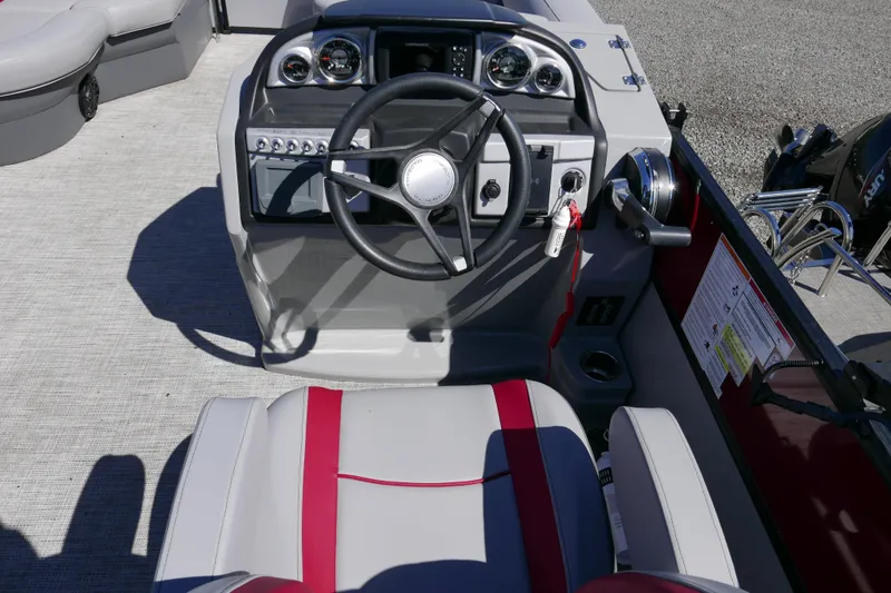 Slide: The Image of 2023 Trifecta C Series boat dashboard with steering wheel and control panel. - 11