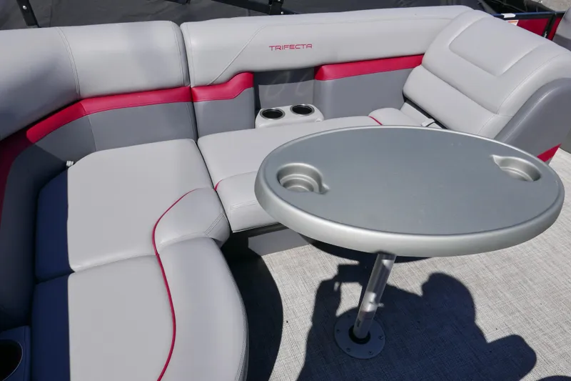 Slide: The Image of Luxurious 2023 Trifecta C Series boat seating with table and cup holders. - 12