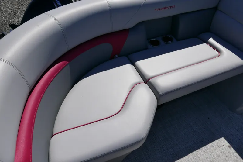 Slide: The Image of 2023 Trifecta C Series boat seating with gray and red upholstery, featuring cup holders. - 6