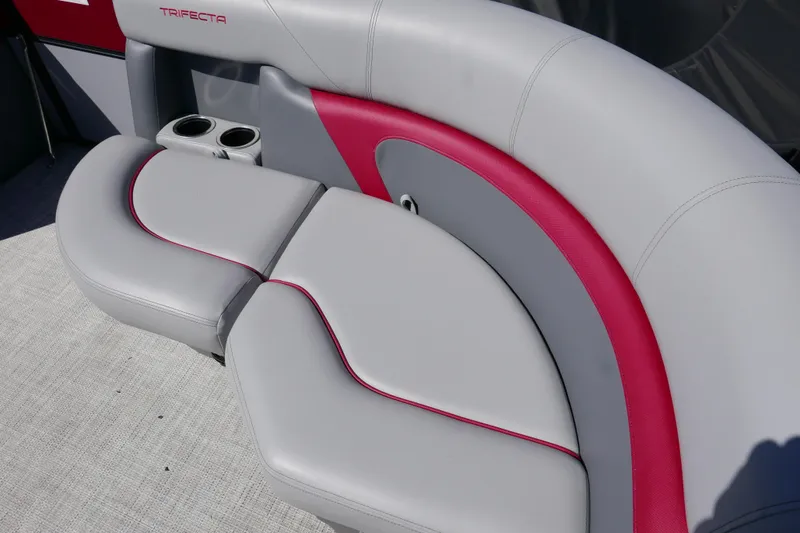 Slide: The Image of 2023 Trifecta C Series boat seating with gray and red upholstery, featuring cup holders. - 7