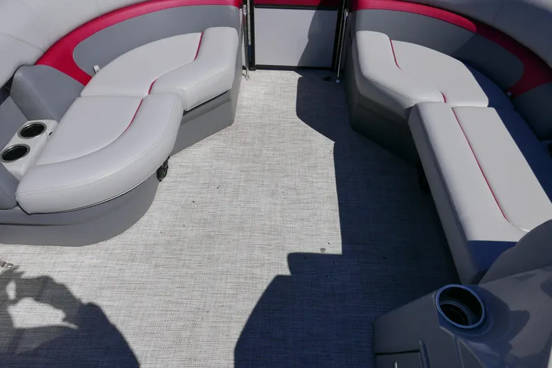 Slide: The Image of 2023 Trifecta C Series boat interior with gray and red seating, cup holders, and carpeted floor. - 8