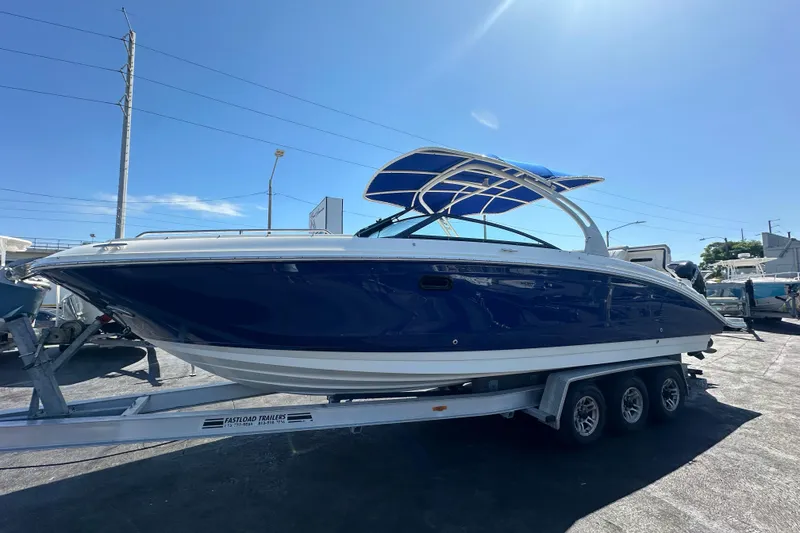 The Image of 2017 Sea Ray SDX 290 Outboard boat on trailer under clear blue sky. - 0