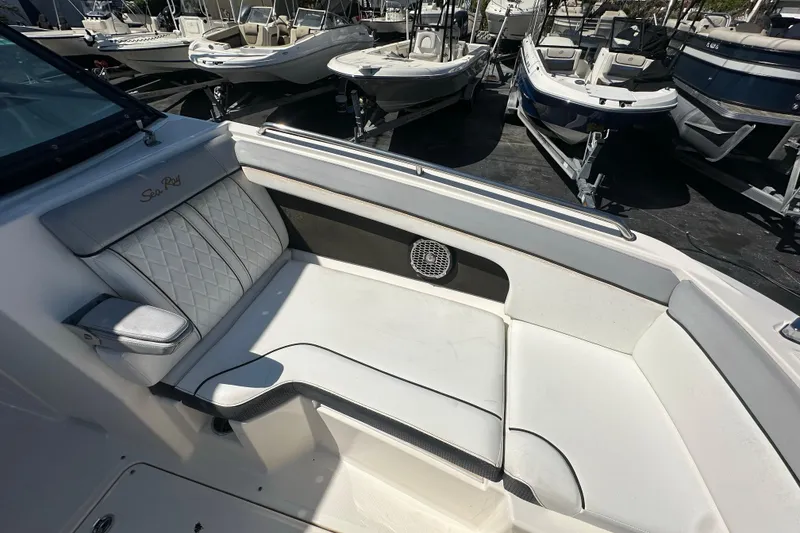Slide: The Image of 2017 Sea Ray SDX 290 Outboard boat interior with white seating and speaker. - 11