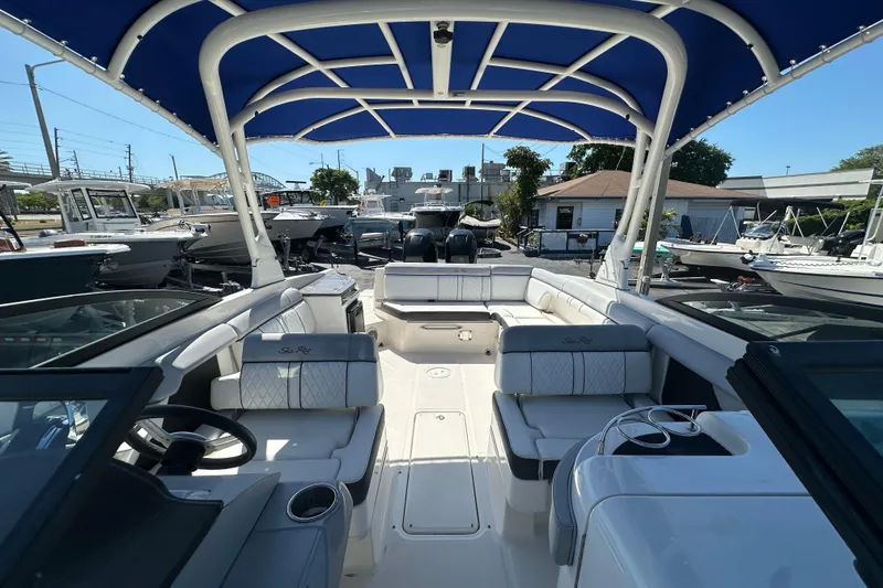 Slide: The Image of 2017 Sea Ray SDX 290 Outboard boat with blue canopy and spacious seating. - 12