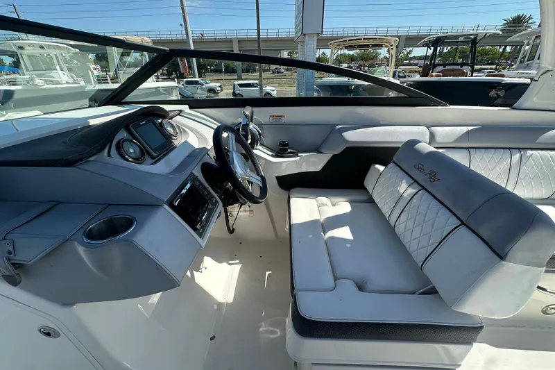 Slide: The Image of 2017 Sea Ray SDX 290 Outboard boat interior with steering wheel and seating. - 16