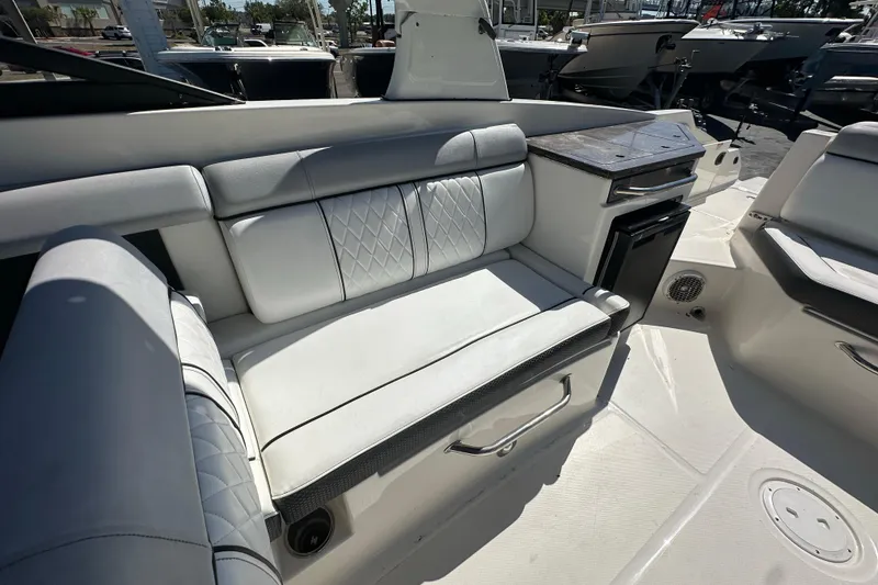 Slide: The Image of 2017 Sea Ray SDX 290 Outboard interior with white seating and storage compartments. - 23