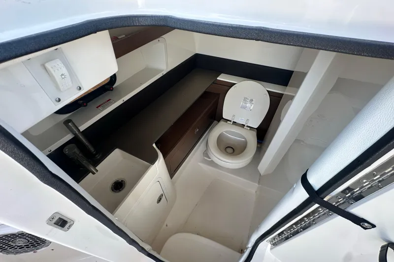 Slide: The Image of Interior of 2017 Sea Ray SDX 290 Outboard boat bathroom with toilet and sink. - 26