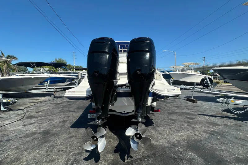 Slide: The Image of 2017 Sea Ray SDX 290 Outboard with dual engines, displayed in a boatyard under clear skies. - 4