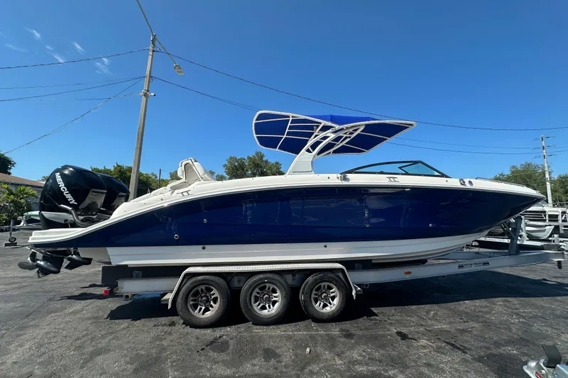 Slide: The Image of 2017 Sea Ray SDX 290 Outboard boat on trailer, blue hull, sunny day. - 7