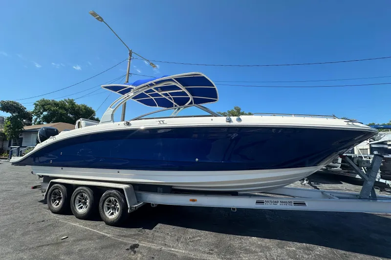 Slide: The Image of 2017 Sea Ray SDX 290 Outboard boat on trailer under clear blue sky. - 8
