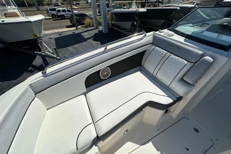 Slide: The Image of 2017 Sea Ray SDX 290 Outboard boat interior with white cushioned seating. - 9