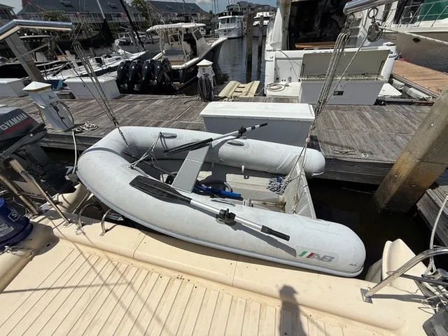 Slide: The Image of 1983 Prout 37 Snow Goose with dinghy at dock. - 12