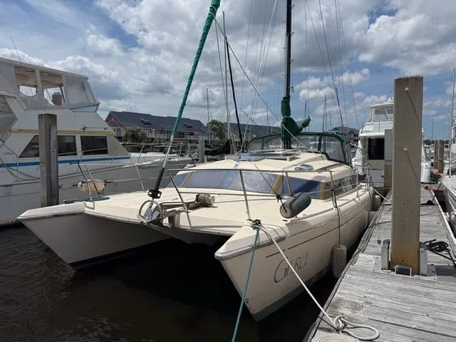 Slide: The Image of 1983 Prout 37 Snow Goose catamaran docked at marina. - 2