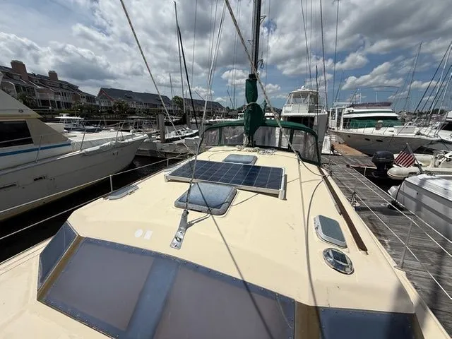 Slide: The Image of 1983 Prout 37 Snow Goose catamaran docked with solar panel. - 3