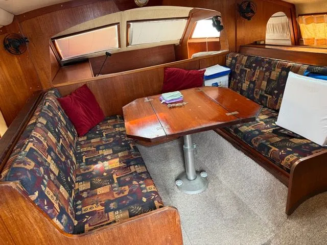 Slide: The Image of Interior of a 1983 Prout 37 Snow Goose yacht with cozy seating area. - 5