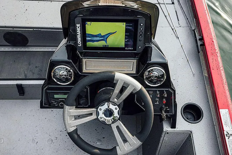 Slide: The Image of Manufacturer Provided Image: 2025 Lowe Stinger 175C boat dashboard with steering wheel and fish finder display. - 4