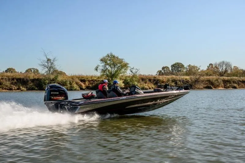 The Image of 2024 Caymas CX 20 boat speeding on a calm river under clear blue skies. - 1