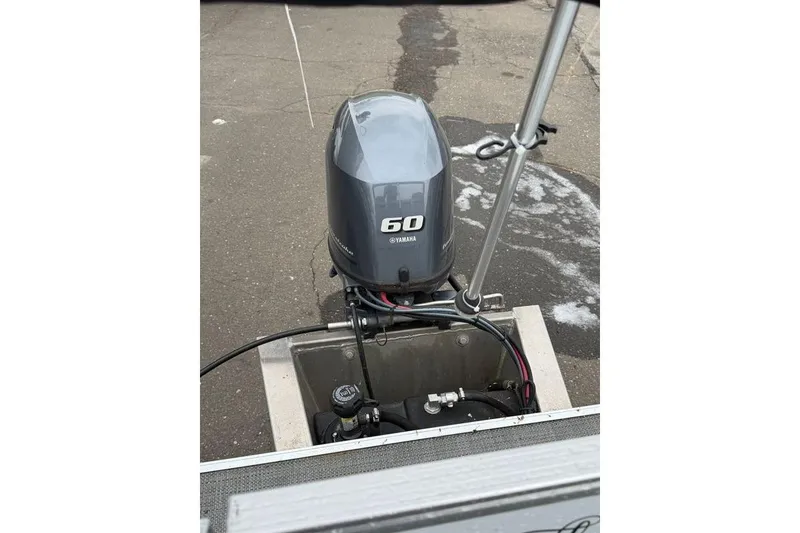 Slide: The Image of Outboard motor on a 2023 Sylvan Mirage 820 LZ boat, docked on pavement. - 12