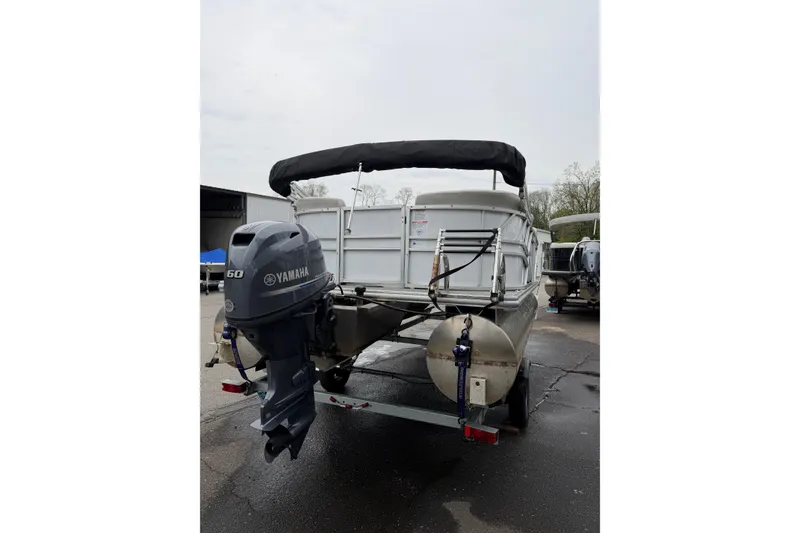 Slide: The Image of 2023 Sylvan Mirage 820 LZ pontoon boat with Yamaha 60 engine, parked outdoors. - 4