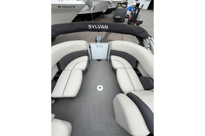 Slide: The Image of 2023 Sylvan Mirage 820 LZ pontoon boat interior with plush seating and sleek design. - 7